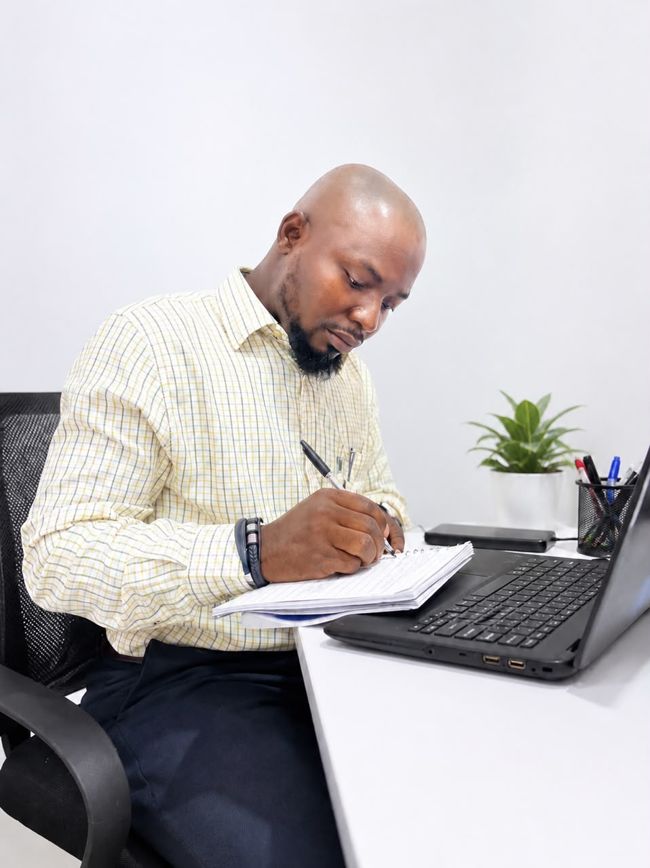 Kabiru Usman working at his desk in the PitchPro office